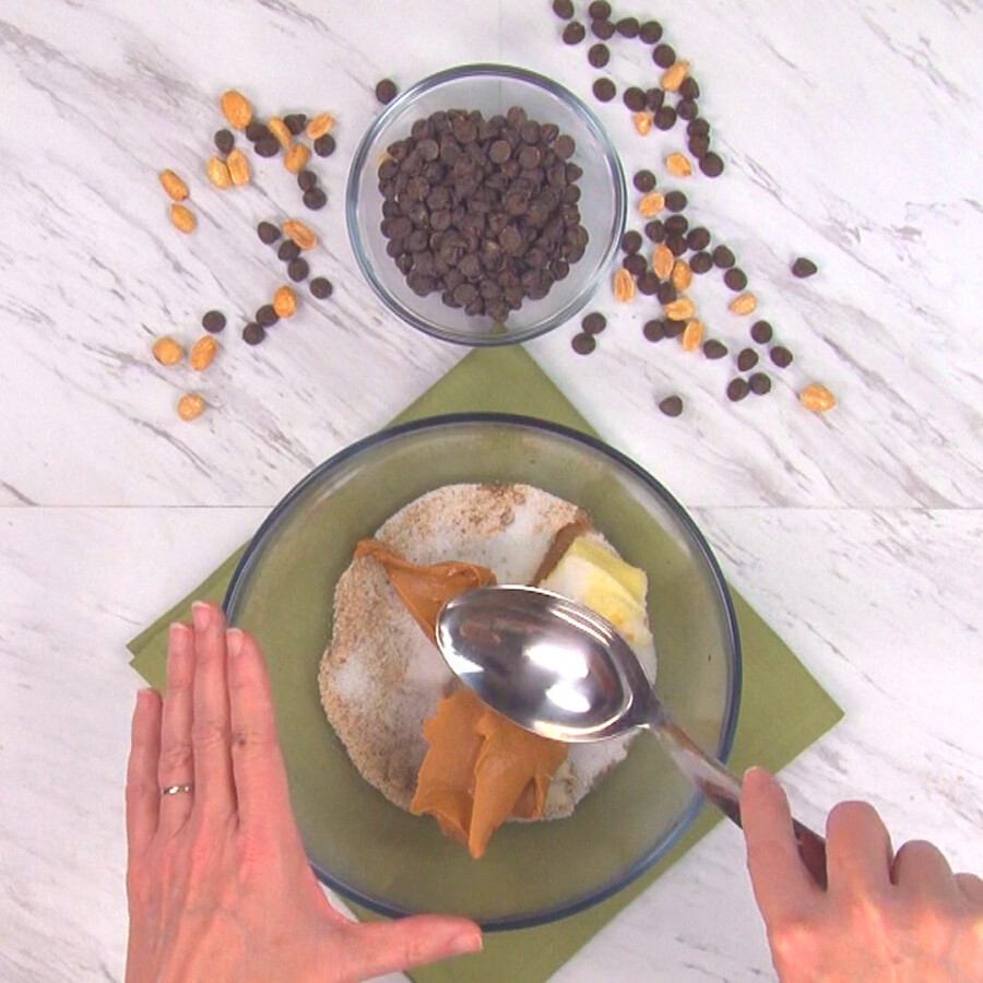 Combining bar base ingredients in a bowl with a spoon
