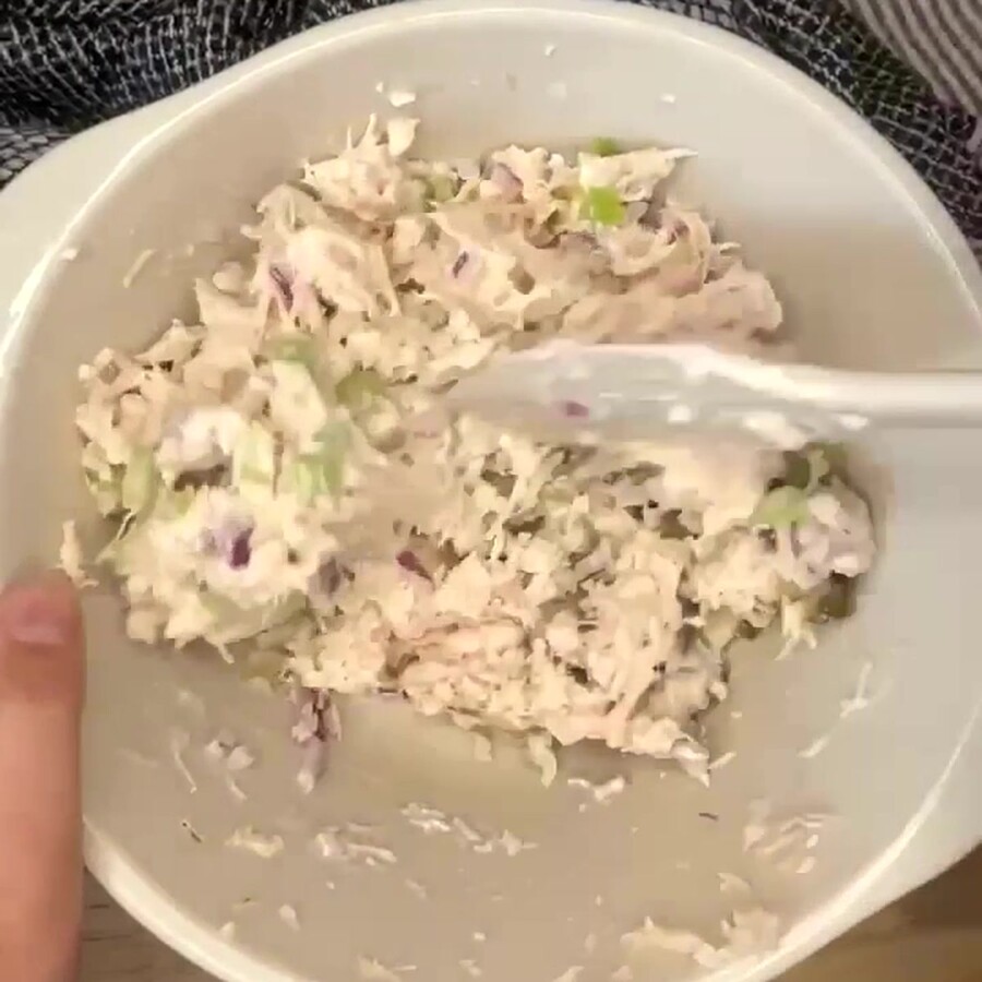 Canned Chicken Salad being stirred together in a bowl with a silicone spatula