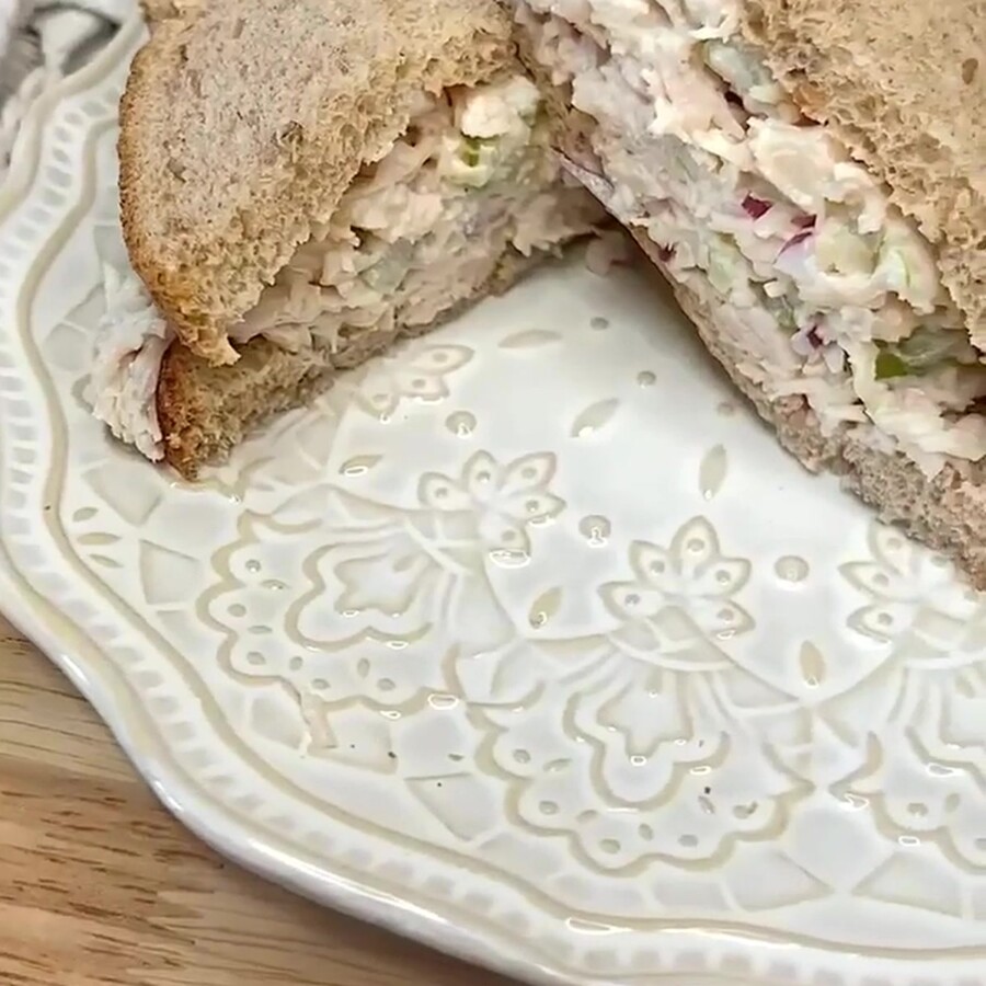 Canned Chicken salad on whole wheat bread to make a sandwich that is cut in half diagonally