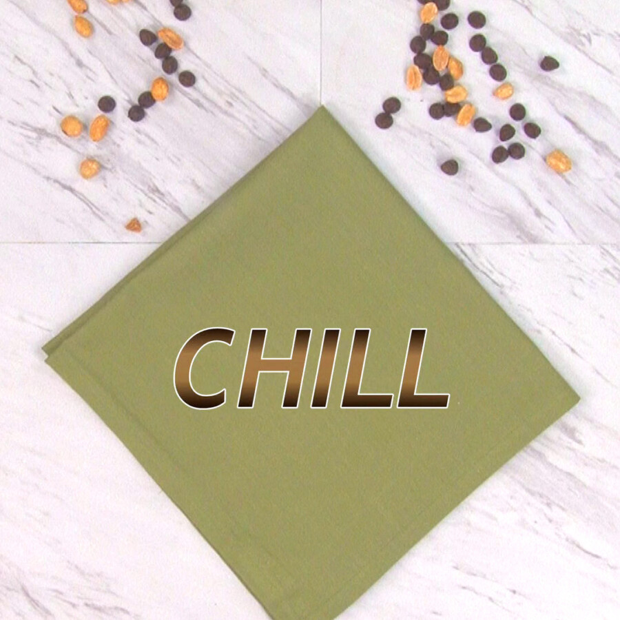A green napkin on a countertop with the word "Chill" on it