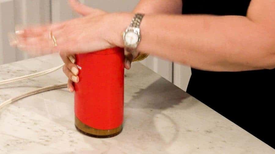 Close up of someone making Garam Masala with a Coffee Grinder.