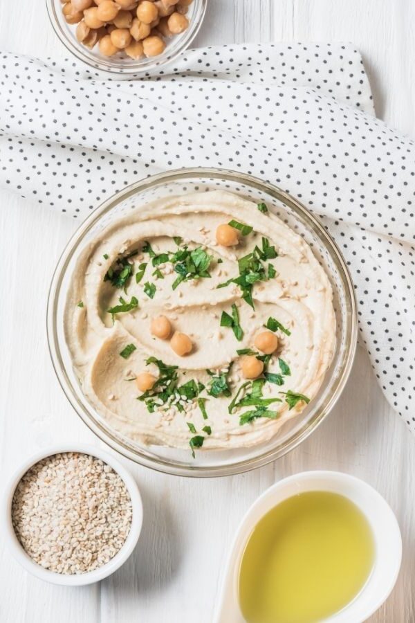 Hummus in a bowl with garnish