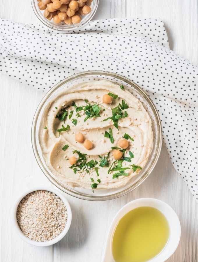 Hummus in a bowl with garnish