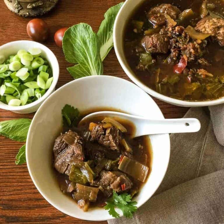 Flavorful, low carb version of Szechuan Pork Soup substitutes bok choy for the noodles, while keeping the traditional flavors of this soup. Pressure cooking makes the meat super tender.