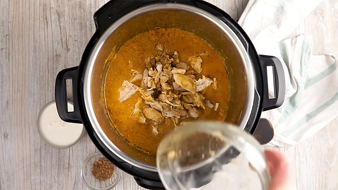 Cut Up Chicken in an Instant Pot with Korma.