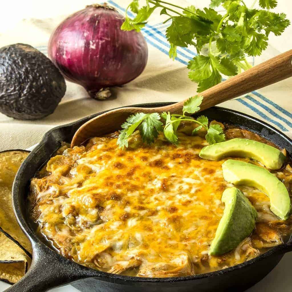 This Pressure Cooker Chicken Enchilada Casserole is so perfect for a busy day. Put everything into the pressure cooker, and then broil the cheesy topping for a few minutes for all of the taste of Chicken Enchiladas, with half the effort.