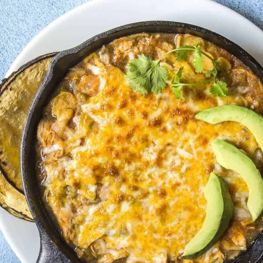 Close up of Chicken Enchilada Casserole in a pan.