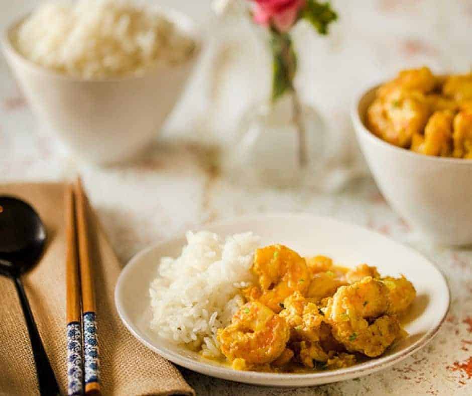 shrimp with coconut milk served with rice in a white bowl 