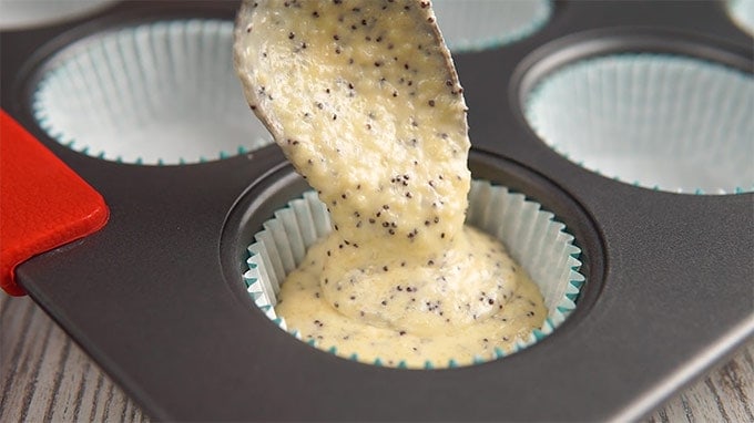 Keto muffin batter being poured into muffin liners