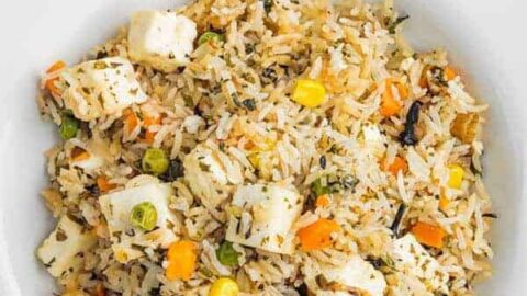 overhead shot of instant pot paneer biryani in a white bowl