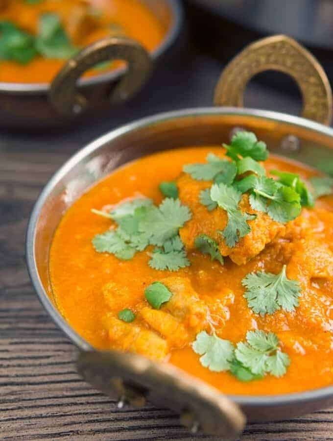 Chicken Vindaloo with cilantro on top served in a dish