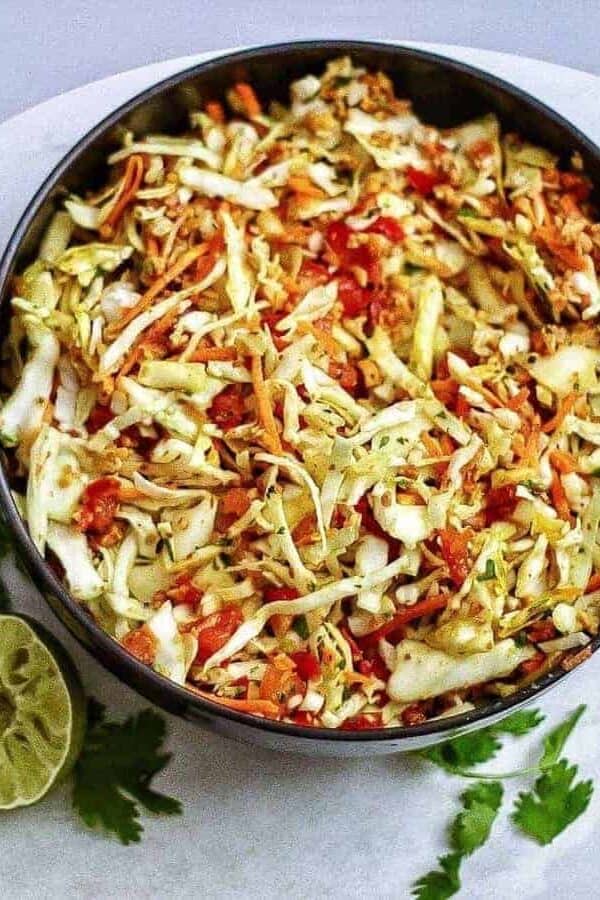 Indian style raw cabbage peanut slaw makes a great accompaniment to any meal. One of my favorite summer salads!| twosleevers
