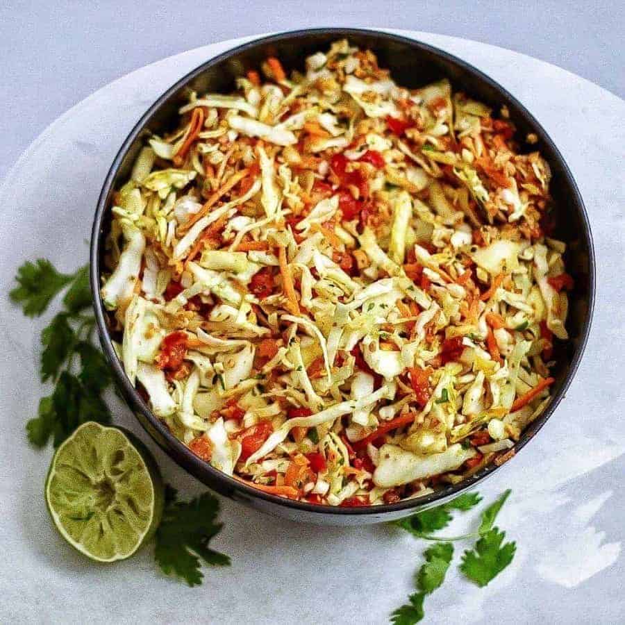 Indian style raw cabbage peanut slaw makes a great accompaniment to any meal. One of my favorite summer salads!| twosleevers