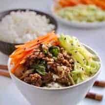 Cook a spicy basil beef along with a pot of rice at the same time in your pressure cooker. Make a quick-pickled salad while they cook, to serve a healthy, fast dinner.