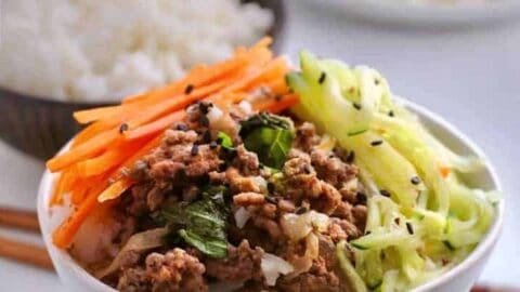 Cook a spicy basil beef along with a pot of rice at the same time in your pressure cooker. Make a quick-pickled salad while they cook, to serve a healthy, fast dinner.