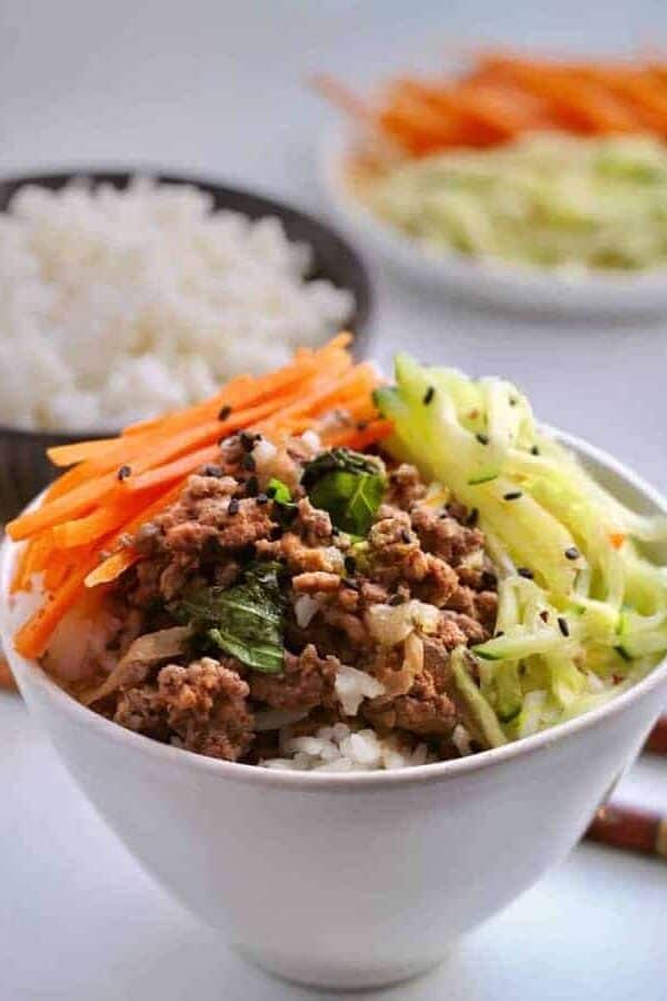 Cook a spicy basil beef along with a pot of rice at the same time in your pressure cooker. Make a quick-pickled salad while they cook, to serve a healthy, fast dinner.