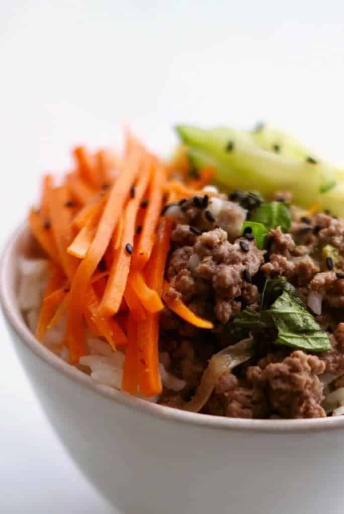 Cook a spicy basil beef along with a pot of rice at the same time in your pressure cooker. Make a quick-pickled salad while they cook, to serve a healthy, fast dinner. 