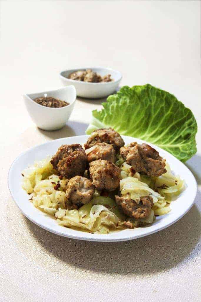 Homemade Instant Pot Low Carb Chicken Bratwurst and Cabbage dinner. This easy chicken sausage recipe makes meatballs that are very mildly spiced but flavorful, and sure to be very kid-friendly.