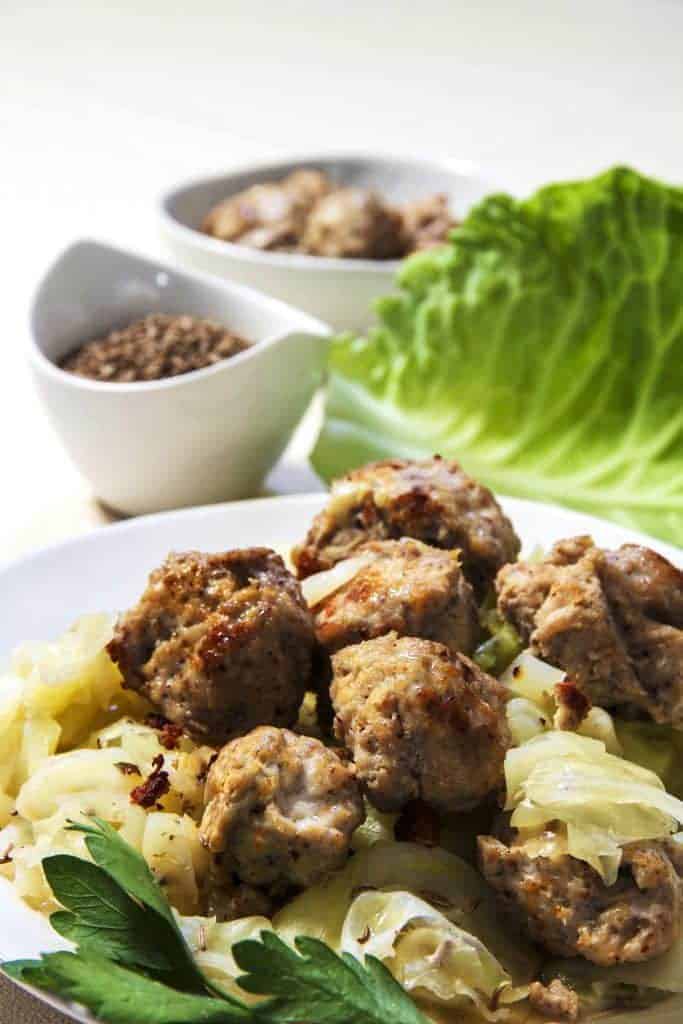 Homemade Instant Pot Low Carb Chicken Bratwurst and Cabbage dinner. This easy chicken sausage recipe makes meatballs that are very mildly spiced but flavorful, and sure to be very kid-friendly.