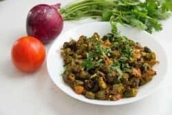 This recipe for Indian Bhindi Masala, or okra with onions and tomatoes, will be the easiest and most authentic recipe you will ever make. Make restaurant-style Bhindi Masala at home with very little effort.
