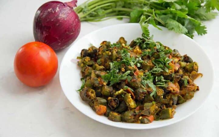 This recipe for Indian Bhindi Masala, or okra with onions and tomatoes, will be the easiest and most authentic recipe you will ever make. Make restaurant-style Bhindi Masala at home with very little effort. 