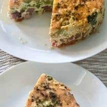slice of broccoli ham pepper with the whole pie in the back