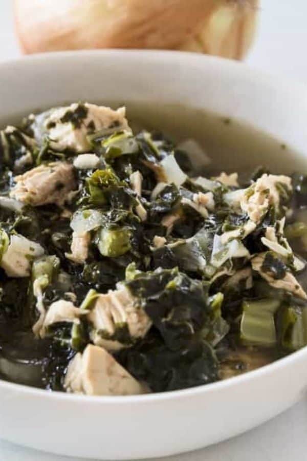 Chicken Kale Soup In A White Bowl