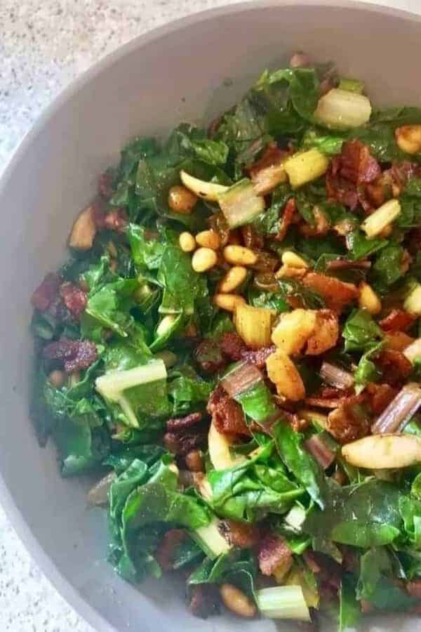 swiss chard with bacon in a white bowl