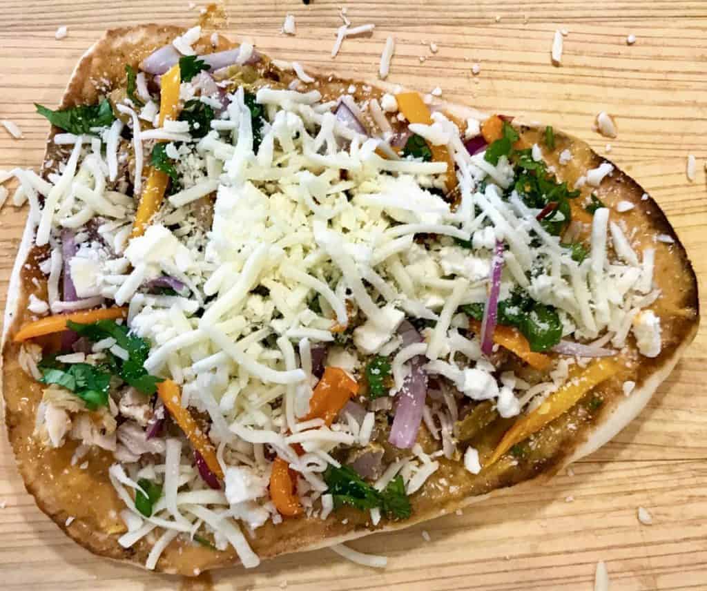 Best and easiest butter chicken pizza ever, and an excellent way to use up your leftover Two Sleevers butter chicken or the extra butter chicken sauce-if you ever have any left, that is. Use ready-made naan to make pizza night even easier. 