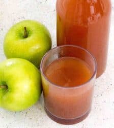 Glass of apple cider with two granny smith apples and a bottle of cider in the back. Here’s how you can start with fresh apples, and end up with some of the most flavorful Mulled Apple Cider you’ve had—in about 30 minutes. Choose the sweetener and spices of your choice to customize this Mulled Apple cider to your taste.