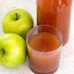Glass of apple cider with two granny smith apples and a bottle of cider in the back. Here’s how you can start with fresh apples, and end up with some of the most flavorful Mulled Apple Cider you’ve had—in about 30 minutes. Choose the sweetener and spices of your choice to customize this Mulled Apple cider to your taste.