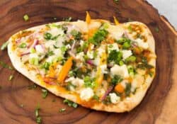 Cooked, finished butter chicken pizza