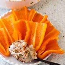 Crazy Good Salmon Cream Cheese Dip Or how to spend $5 and have it taste like you spent about 4 times that much. Sophisticated, smoky, creamy, and absolutely yummy, this 5-ingredient salmon cream cheese dip is a crowd pleaser. 6 oz canned salmon, skinless, boneless 8 oz cream cheese 1 tablespoon Liquid smoke 1/4 cup chopped green onions 1/3 cup chopped pecans or walnuts 1 teaspoon Salt 1-2 teaspoons ground Pepper For Finishing 1 teaspoon Paprika for garnish Bring cream cheese to room temperature and mash with the back of a fork to soften. Gently mix in all the remaining ingredients. Allow dip to rest for 30 minutes at room temperature and mix once again. Garnish with paprika for a burst of color before serving.