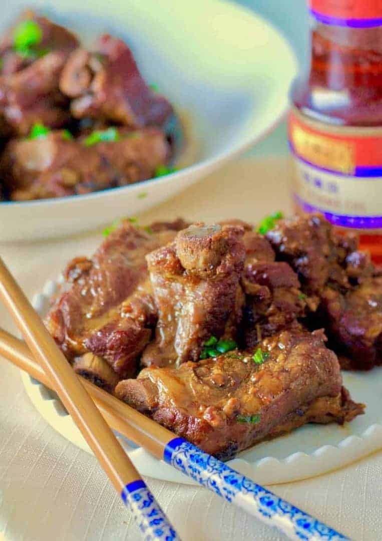 A plate of Chinese Braised Ribs with chopsticks.