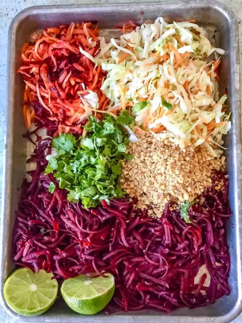 Overhead shot of beet salad ingredients laid out on a sheet pan.