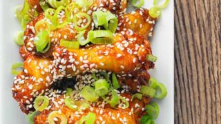 overhead view of gochujang chicken wings on white plate