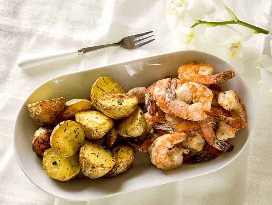 Air Fried Salt and Pepper Shrimp on a platter with roasted potatoes and a fork