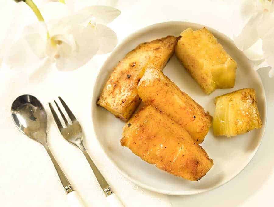 Brazilian Grilled Pineapple spears in a white plate, overhead view