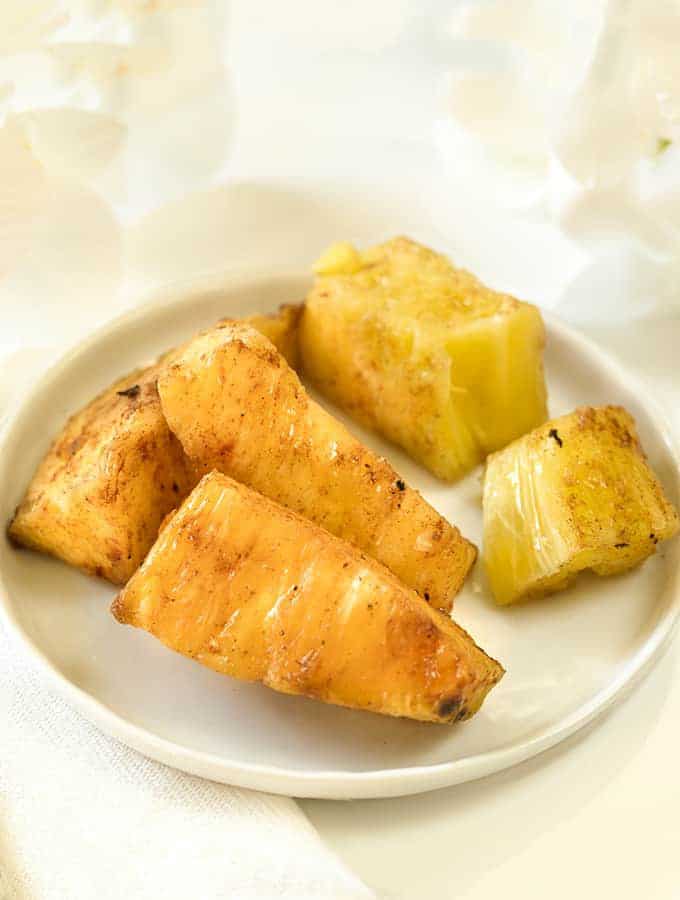 Brazilian Grilled Pineapple spears in a white plate, sideways view