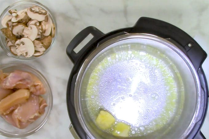 Overhead shot of butter and garlic sauteing in the Instant Pot.