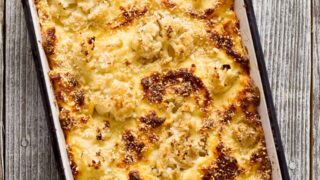 Keto Mac and Cheese in a casserole dish against a gray background
