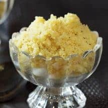 Instant Pot Halva recipe in footed glass bowl against a black background
