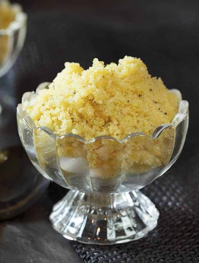 Instant Pot Halva recipe in footed glass bowl against a black background