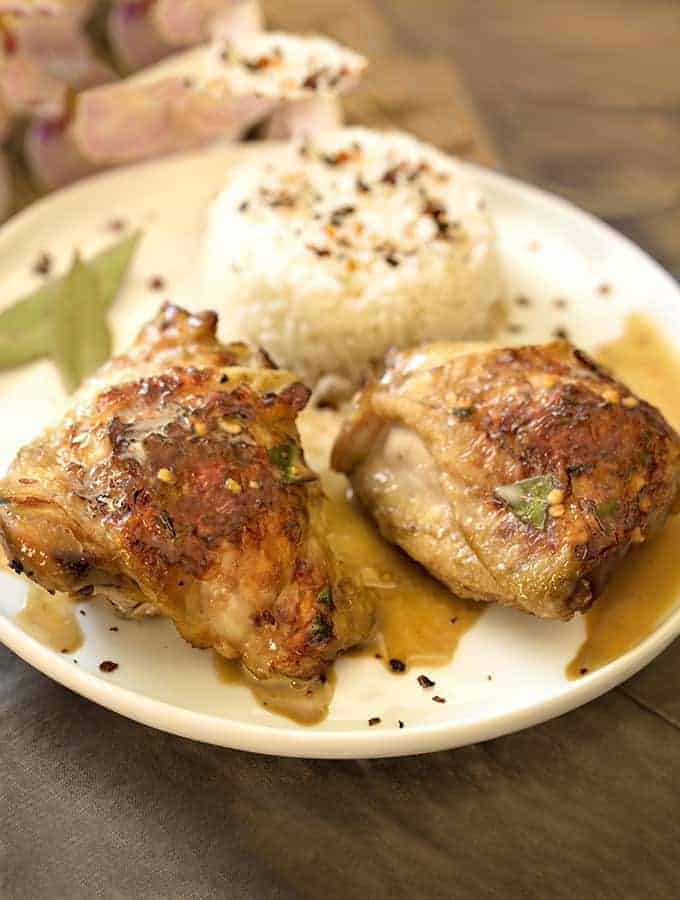 Instant Pot Chicken Adobo on a white plate with rice on the side.