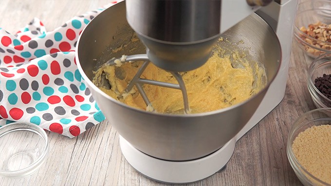 Side shot of mixing the eggs into the batter.
