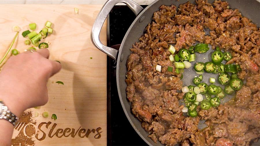 Make a well in the center, and add green chilis Make a well in the center, and add green chilis