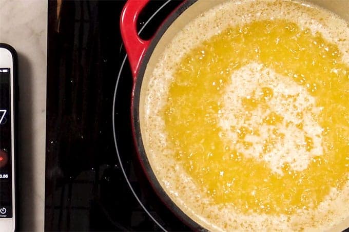 Overhead shot of butter cooking in a pan.