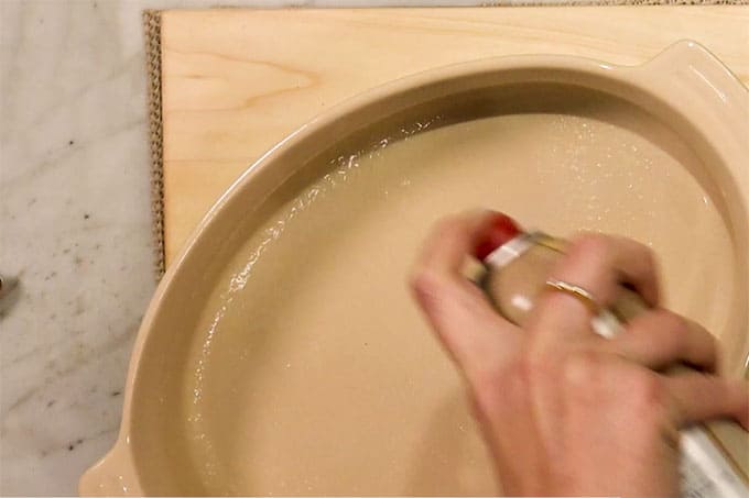 Overhead shot of spraying pan before adding ingredients.