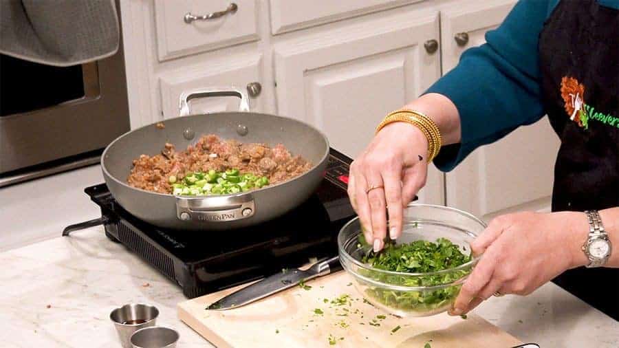 Side shot of mixing the cilantro and onions together.