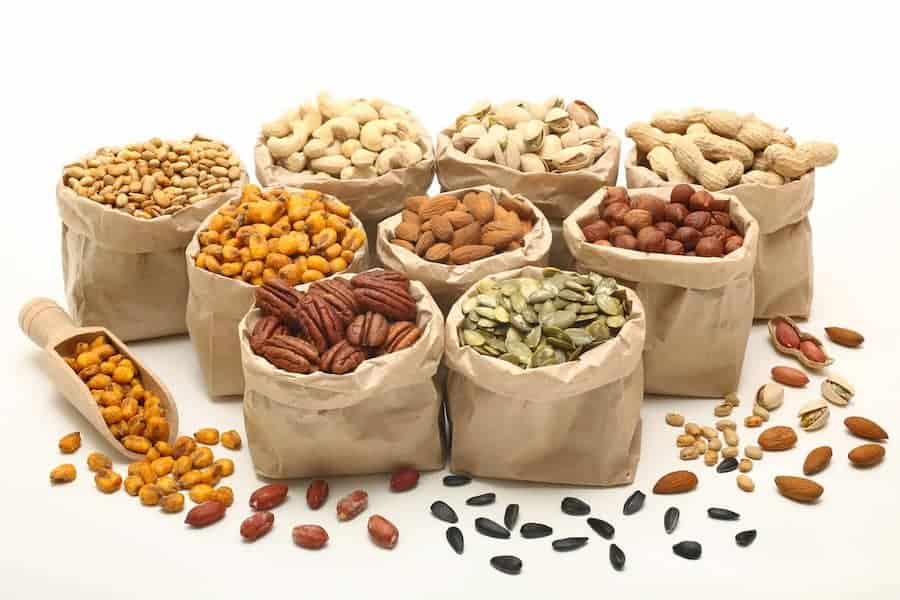 small brown paper bags of mixed nuts and seeds for keto snacks